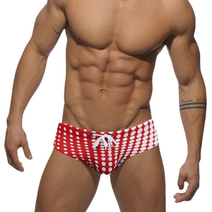 Men's low waist swim briefs with red and white polka dot pattern and waist drawstring