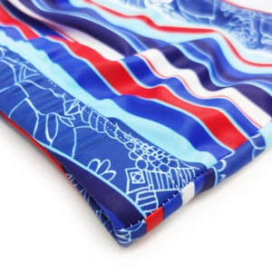 Macro shot of striped swimwear fabric with blue floral patterns and durable stitching