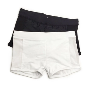Flat lay of high-waisted volleyball shorts with mesh side panels in black and white