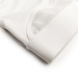 Macro detail of white men's swim briefs featuring breathable mesh and elastic waistband
