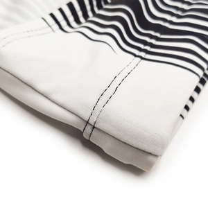 Close-up of black and white striped swim trunks with high-elastic fabric and double stitching