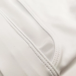 Detailed macro view of white breathable mesh stitching and flatlock seams on swimwear
