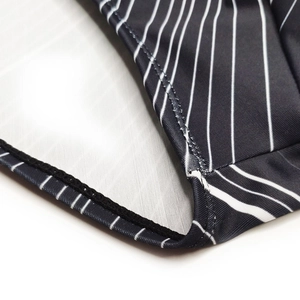 Close-up of black swimwear fabric with white stripes showing high-quality stitching detail