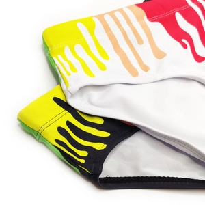 Macro shot of colorful paint drip prints on quick-dry men's swim briefs with elastic waist