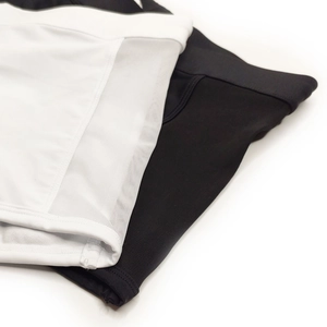 Detailed macro view of men's athletic shorts with breathable side mesh panels in black and white