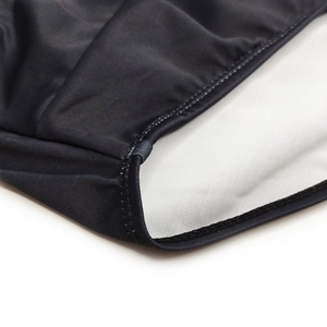 Detail view of reinforced stitching and white lining on men's black swim briefs