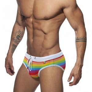 Close-up of rainbow striped swim briefs featuring a white drawstring and elastic waistband