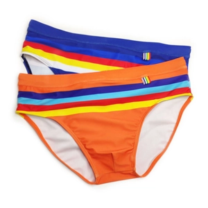 Flat lay of men's striped swim briefs in navy and orange quick-dry fabric details