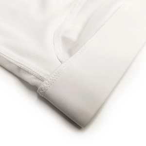 Macro detail of breathable mesh fabric and elastic waistband with flatlock stitching