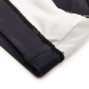 Macro detail of high-elastic stitching and black-white contrast seam on swim briefs