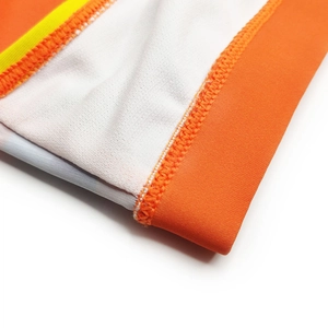 Detailed macro view of multi-color striped elastic fabric and professional flatlock stitching