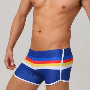 Detail of men's quick-dry navy swim trunks with colorful stripes and white piping trim