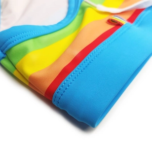 Detailed close-up of rainbow striped swimwear featuring high-elastic fabric and fine stitching