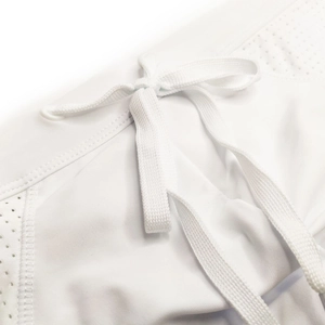 Macro detail of white men's swim briefs featuring drawstring waist and mesh breathable panels