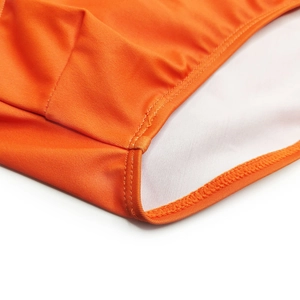 Detail view of bright orange men's swimwear featuring durable double-needle stitching and soft lining