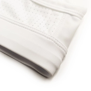 Close-up of breathable mesh fabric and elastic seams on white men's swim briefs