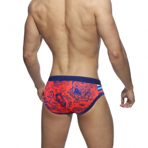 Men's low-rise swim briefs in vibrant red with navy cartoon graffiti prints and wide waistband