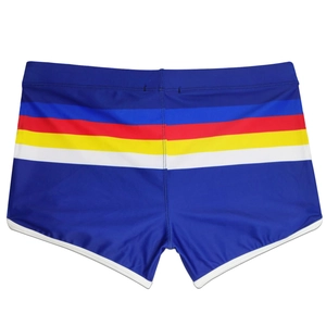 Close-up of royal blue swim trunks with vibrant rainbow stripes and white elastic piping