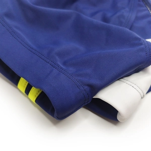 Macro detail of navy sports swim briefs showing white stitching and yellow stripes