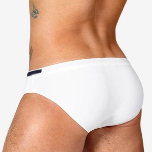 Close-up detail of white men's swim briefs showing elastic fabric and side blue ribbon buckle