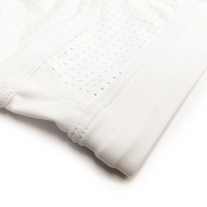 Detail view of white mesh swim briefs with reinforced stitching and elastic waistband