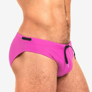 Close-up of rose red swim briefs featuring a black drawstring with metallic tips