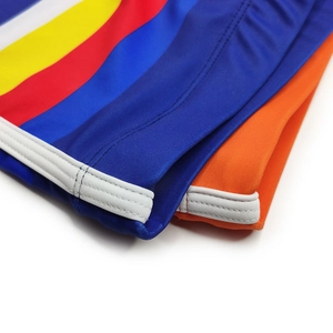 Detail of high-elasticity swimming trunks with rainbow stripes and orange fabric stitching