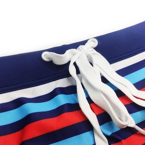 Close-up of multicolor striped swimwear featuring elastic waist with white drawstring detail