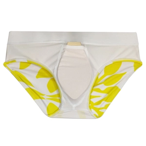 Detail of white men's swim trunks featuring yellow leaf print and protective padded pouch