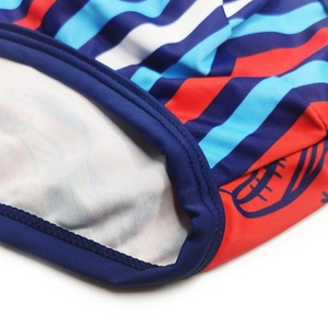 Close-up of elastic striped swim trunks with detailed stitching and rugby print