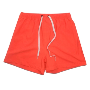 Detailed view of elastic waistband and white drawstring on orange quick-dry sports shorts
