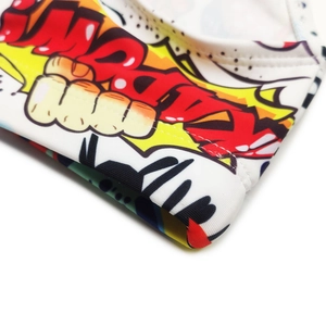 Close-up of quick-dry men's swim trunks featuring pop art graffiti prints and double stitching