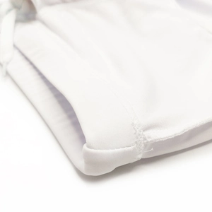 Close-up of premium stitching and high-elastic fabric detail on white swim trunks