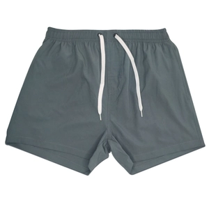 Detail of grey-blue quick-dry sports shorts with elastic waist and white drawstrings