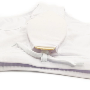 Detailed macro view of men's white swim trunks showing the protective pad slot and drawstring