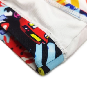 Detail of high-density elastic fabric with cartoon print and precision double stitching
