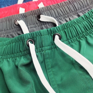 Detail of four-way stretch quick-dry men's shorts with elastic waist and metal eyelets