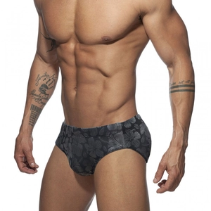 Men's low-rise swim briefs with gray tropical hibiscus pattern shown on male model