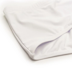 Detailed close-up of white swim trunks featuring elastic waistband and reinforced stitching
