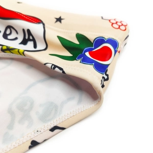 Close-up of leopard head graffiti print on beige swimming briefs with flat seam stitching