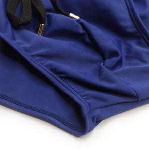 Detail of blue swim briefs featuring side pocket and adjustable drawstring with metal tips