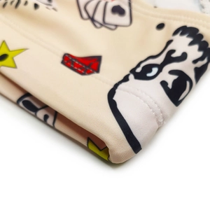 Macro detail of graffiti patterns on beige fabric with seamless stitching and star prints