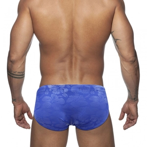 Detailed back view of royal blue swim briefs featuring light blue hibiscus floral patterns