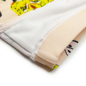 Close-up of leopard print swim briefs showing high-elastic fabric and fine flatlock stitching