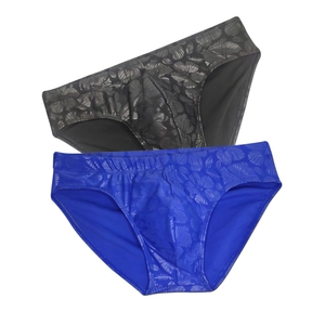Detail of quick-dry swim briefs with tropical hibiscus print in black and blue