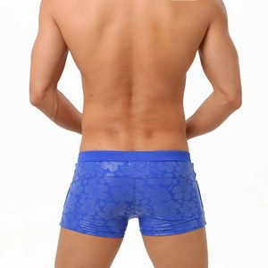 Rear view of men's blue hibiscus print swim trunks with floral patterns and slim fit cut