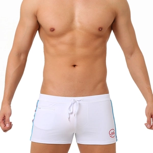 Detail of white swim trunks with blue and red side stripes and a secure zipper pocket