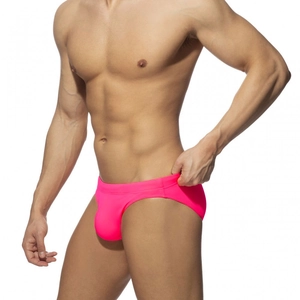 Detail view of hot pink mens swim briefs showing high elastic quick dry fabric texture