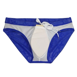 Flat lay of navy blue floral swim briefs featuring white drawstring and palm leaf print