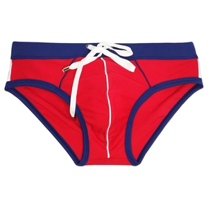 Close-up of red and blue color-block men's swim briefs with white drawstring detail